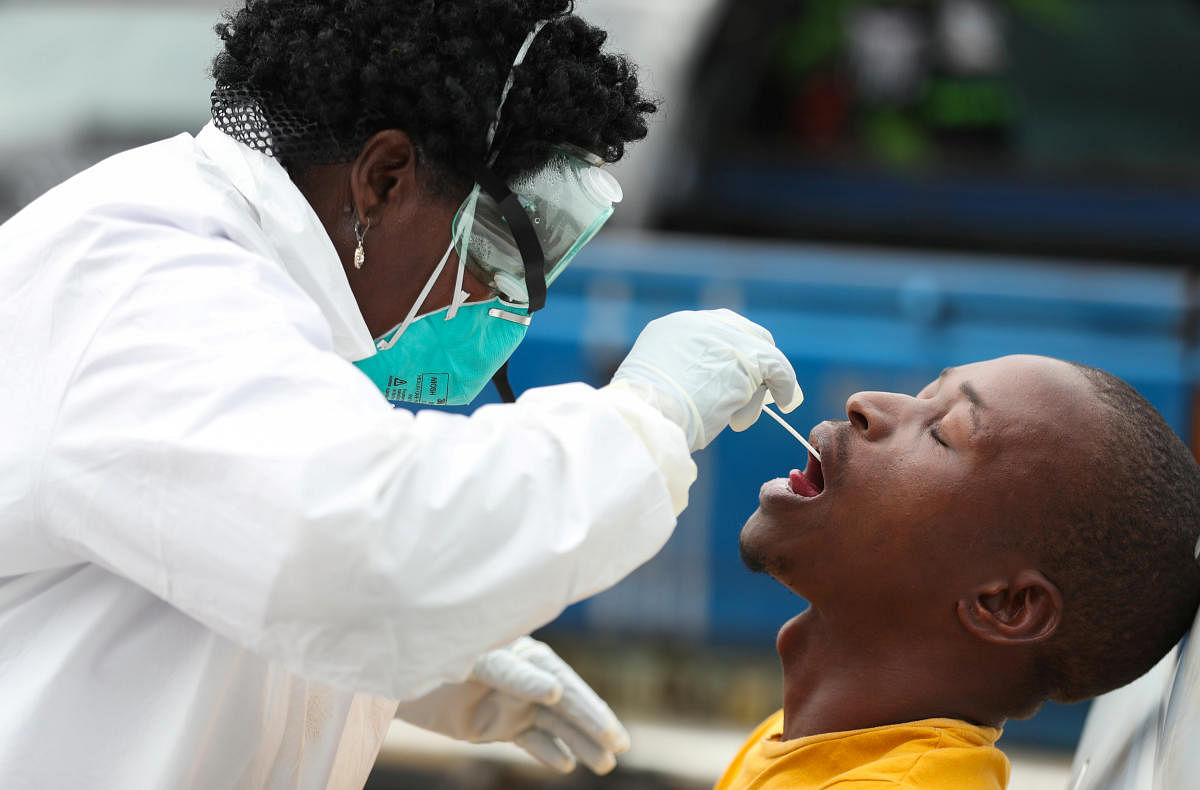 A member of medical staff swabs the mouth of a resident as she is testing him for a virus, during a nationwide lockdown for 21 days to try to contain the coronavirus disease (COVID-19) outbreak, in Alexandra, South Africa, March 31, 2020. Credit: Reuters Photo