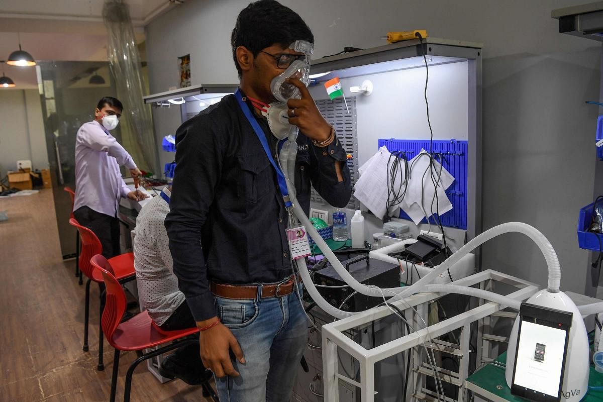 AgVa Healthcare employee Vaibhav Gupta demonstrates using a ventilator. AFP