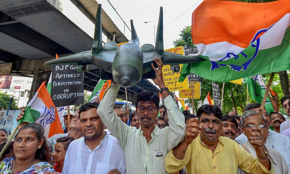 Congress activists during a demonstration rally to protest against the reported scam in Rafale deal, in Kolkata on Friday. PTI