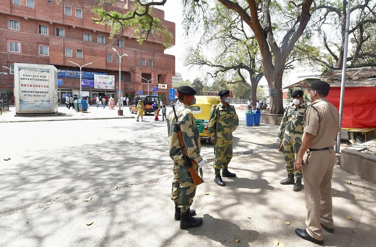 Security personnel stand guard at LNJP hospital as a precaution in the wake of coronavirus pandemic during a nationwide lockdown, in New Delhi, Tuesday, March 31, 2020. (PTI Photo