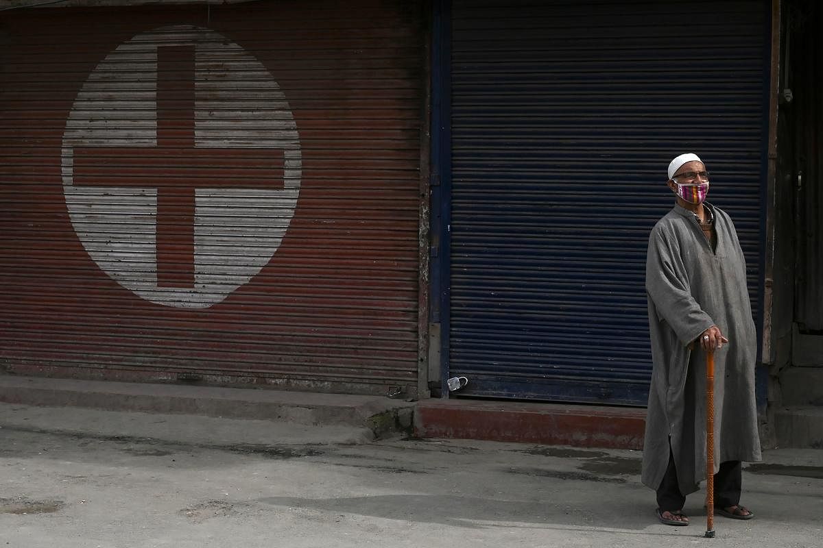 An elderly man wearing a facemask walks along a street during a government-imposed nationwide lockdown as a preventive measures against the COVID-19 coronavirus, in Srinagar on April 3, 2020. Credit: AFP Photo