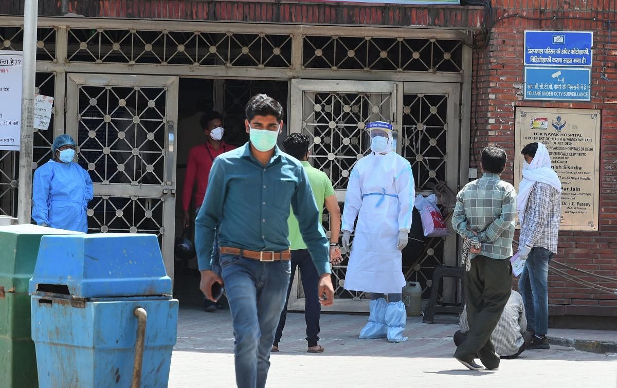 New Delhi: A medic wearing a protective suit as a preventive measure against coronavirus, stands outside the building gate of Lok Nayak Jai Prakash Narayan (LNJP) hospital, in New Delhi, Friday, April 3, 2020. LNJP is among few hospitals in Delhi where CO