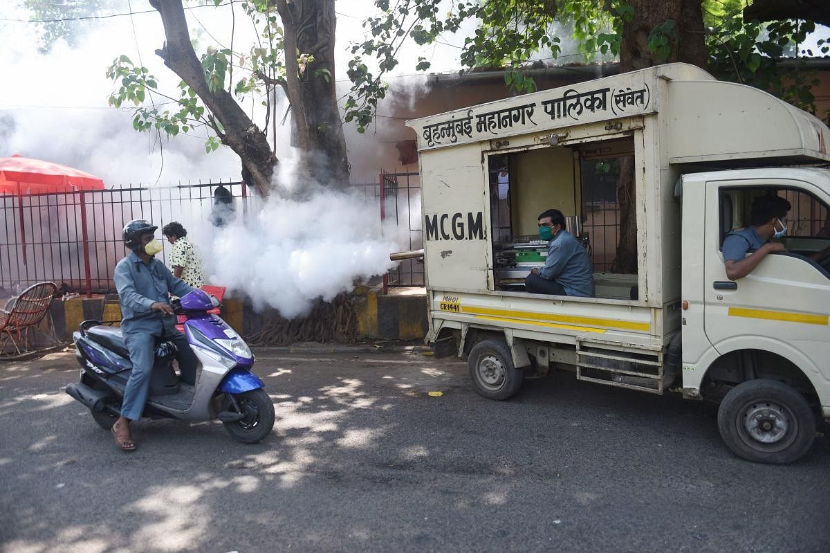  Brihanmumbai Municipal Corporation (BMC) workers fumigate a locality during a nationwide lockdown in the wake of coronavirus outbreak, in Mumbai (PTI Photo)