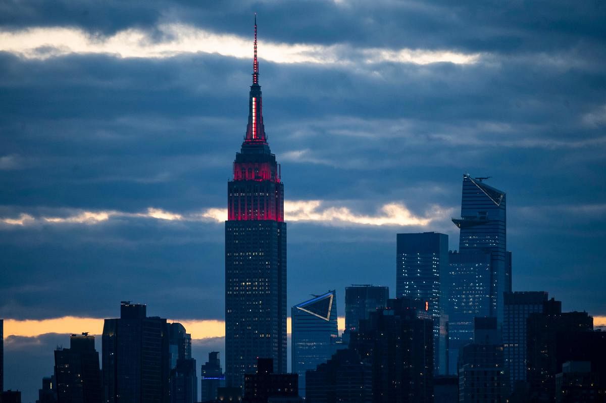The Empire State Building is lit white and red to pay tribute to medical workers battling the coronavirus outbreak in New York City. AFP/File