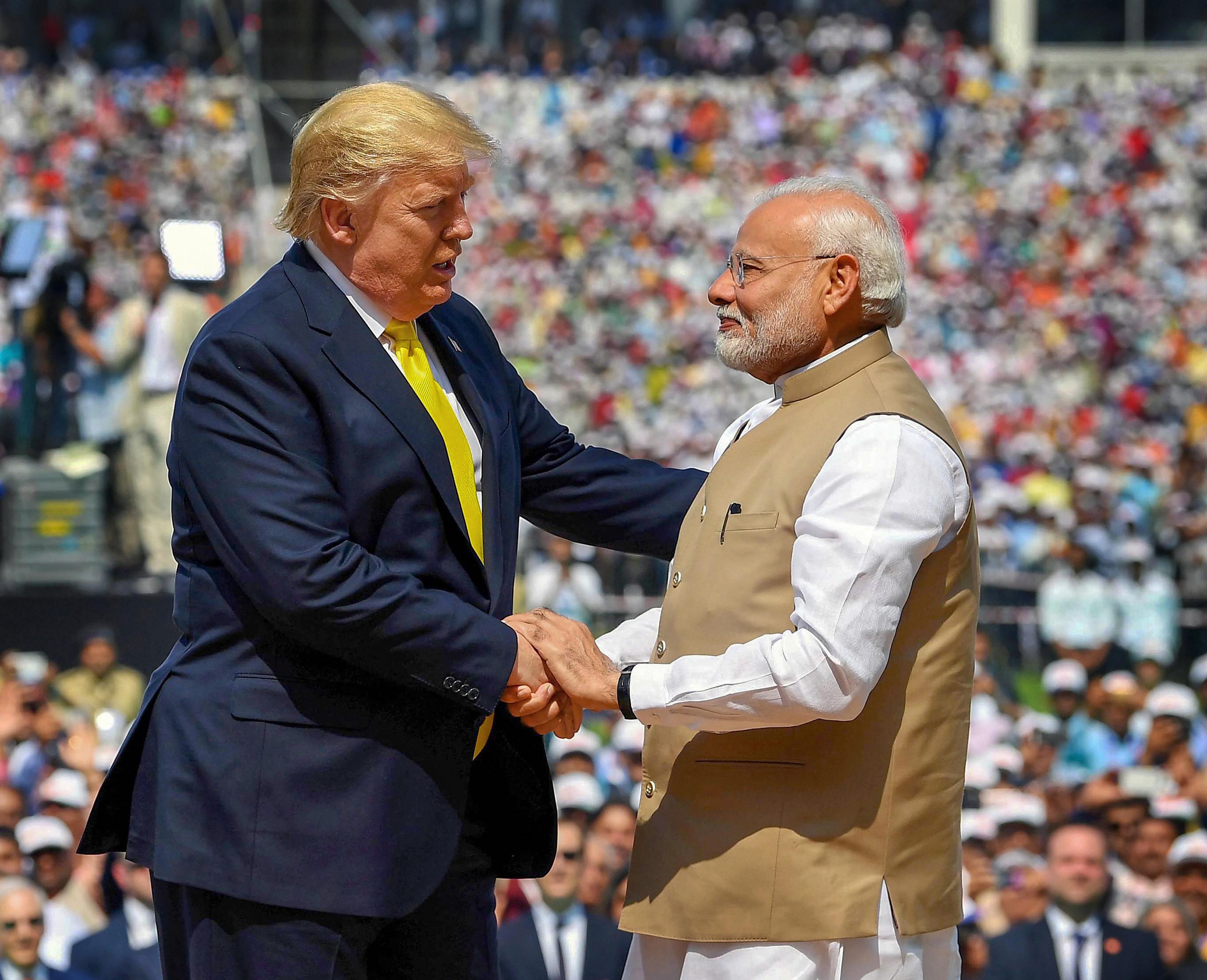US President Donald Trump and Indian PM Narendra Modi greet each other. (Credit: PTI)