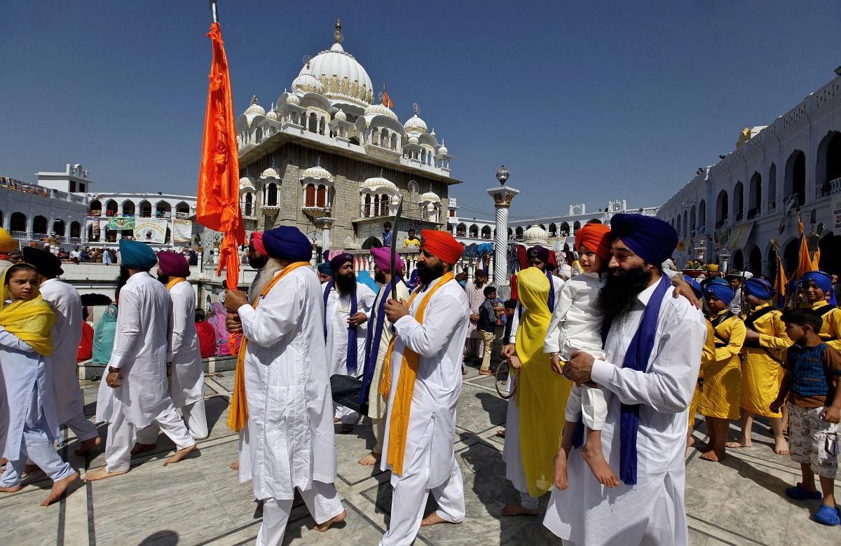 Sikh pilgrims march during the Vasakhi festival, at the shrine of Gurdwara Punja Sahib, the second most sacred place for Sikhs, in Hasan Abdal, some 50 kilometers (31 miles) from Islamabad, Pakistan, Saturday, April 14, 2018. Credit: PTI Photo
