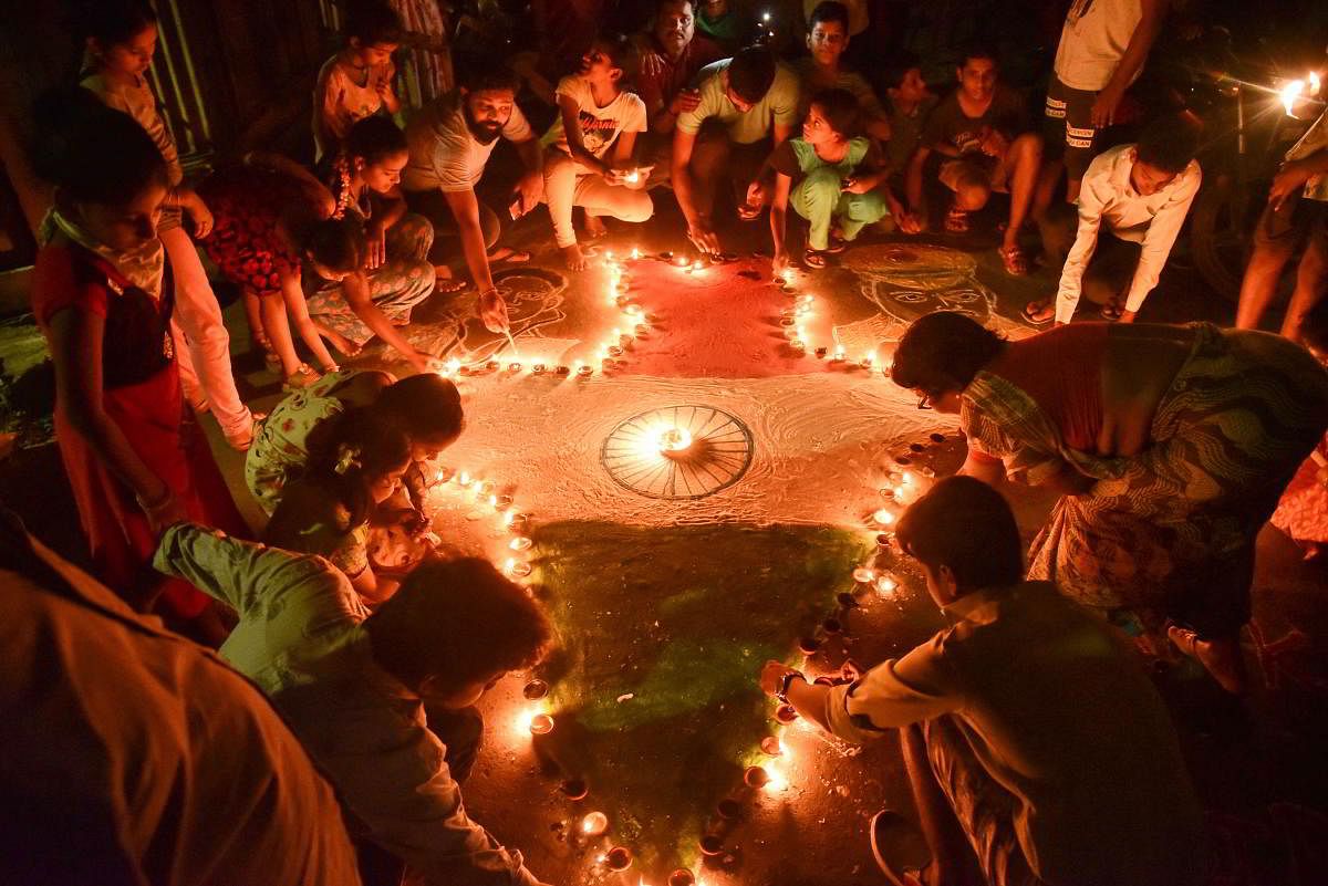 People make a map of India with traditional lamps amid the ongoing nationwide lockdown in the wake of coronavirus pandemic, in Vijayawada. (PTI Photo)