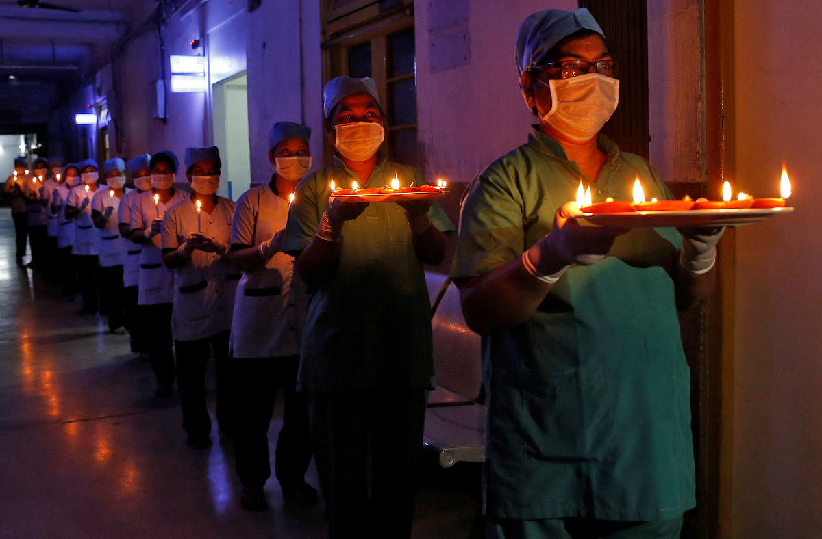 Staff members of a hospital carry candles and oil lamps to show solidarity with people who are affected by the coronavirus, and with doctors, nurses and other healthcare workers from all over the world during a 21-day nationwide lockdown in Kolkata, April