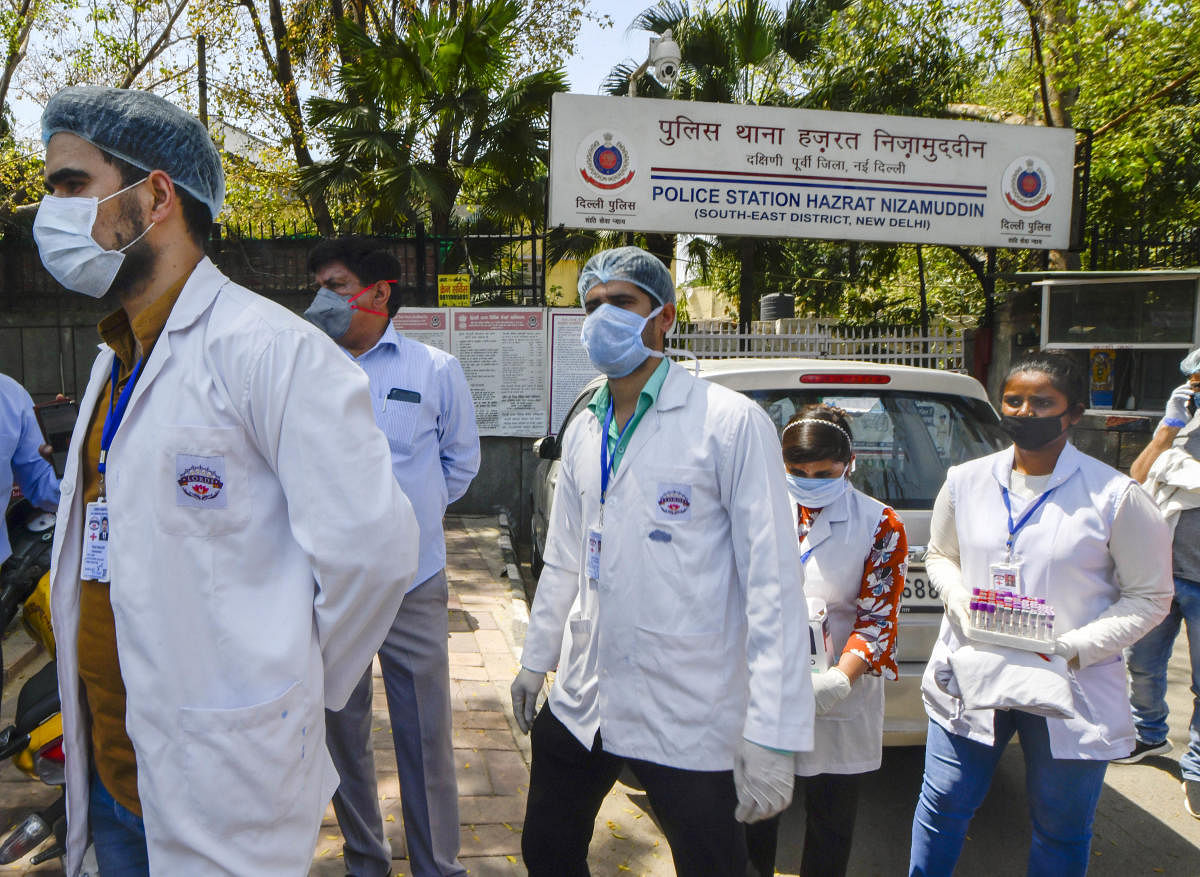 A team of doctors come out of Nizamuddin police station after conducting a routine health check-up, during the nationwide lockdown to curb the spread of coronavirus. PTI