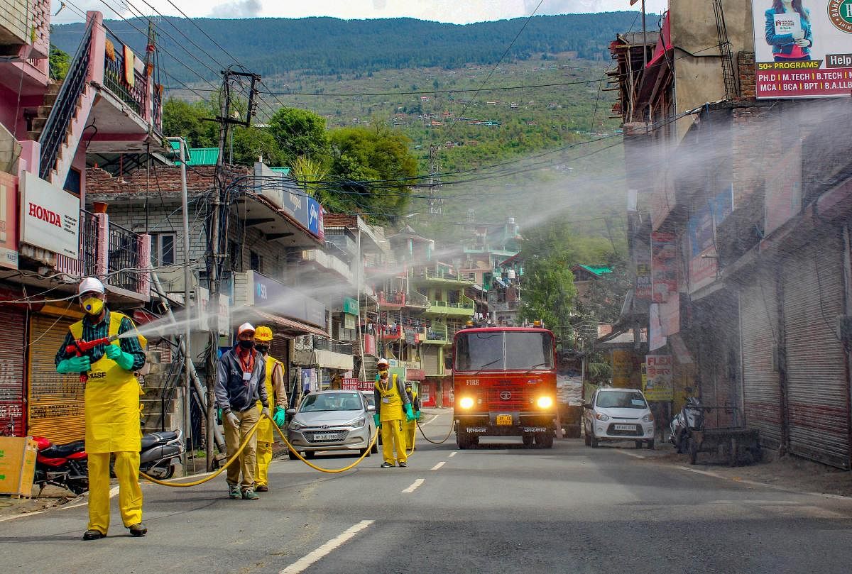 Fire Brigade personnel sanitise a locality in a bid to check the spread of coronavirus, in Kullu, Tuesday, April 7, 2020. (PTI Photo)