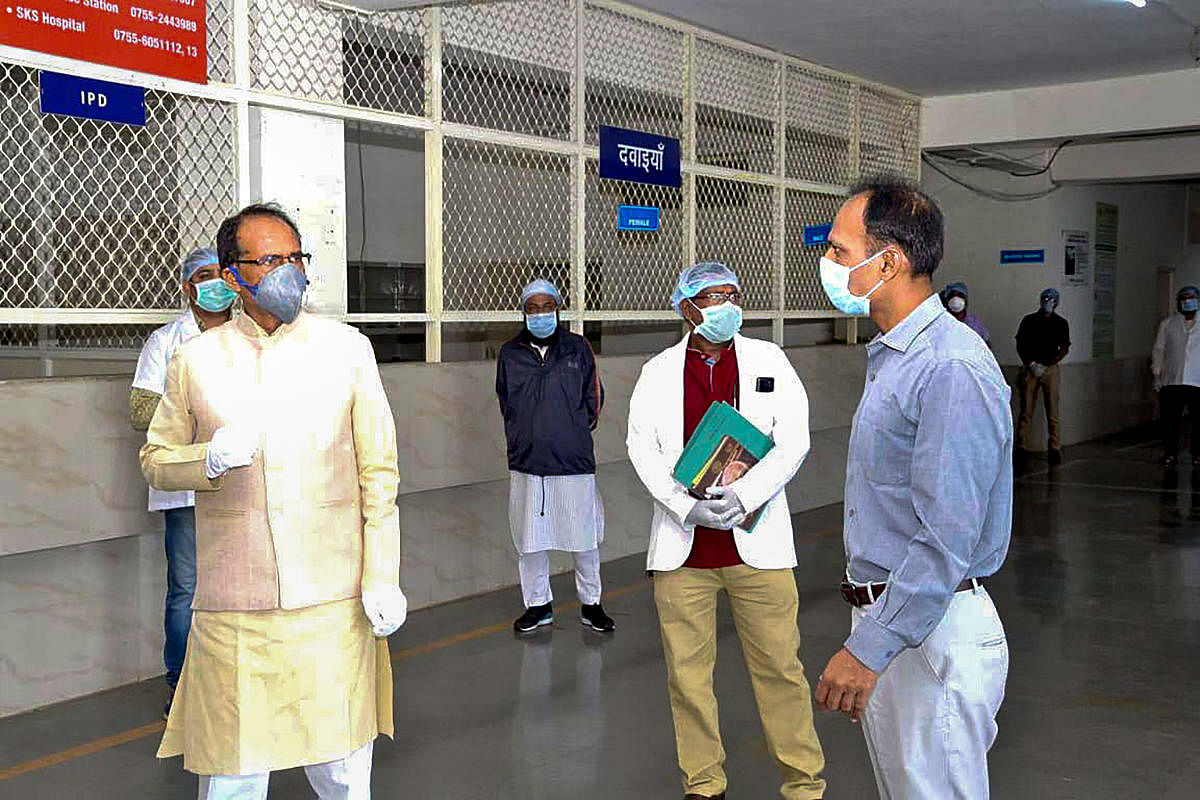 Madhya Pradesh Chief Minister Shivraj Singh Chouhan reviews the facilities which will be granted to coronavirus-affected patients, during a nationwide lockdown, at Advanced Institute Of Medical Sciences in Bhopal. (PTI Photo)