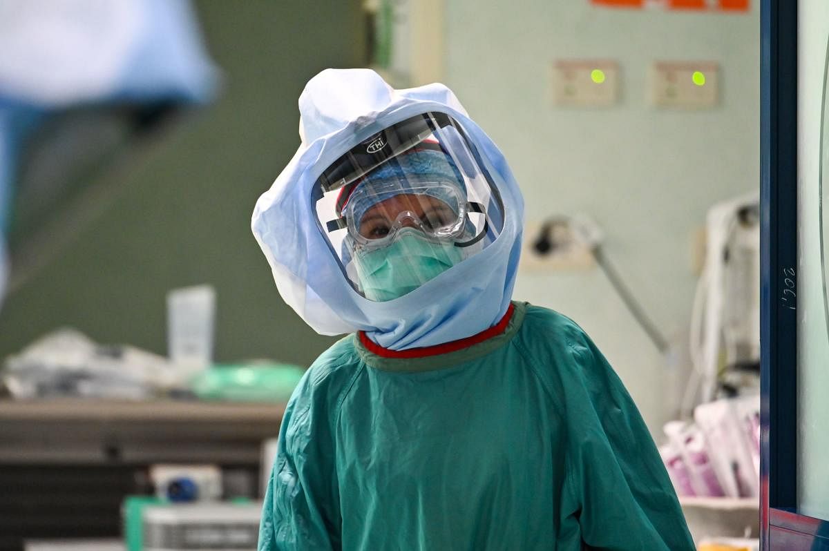 A member of the medical staff wearing the Personal Protective Equipment (PPE) looks on at the Intensive care unit for patients infected by the novel coronavirus COVID-19 at the Policlinico di Tor Vergata hospital, in Rome on April 8, 2020. Credit: AFP Photo