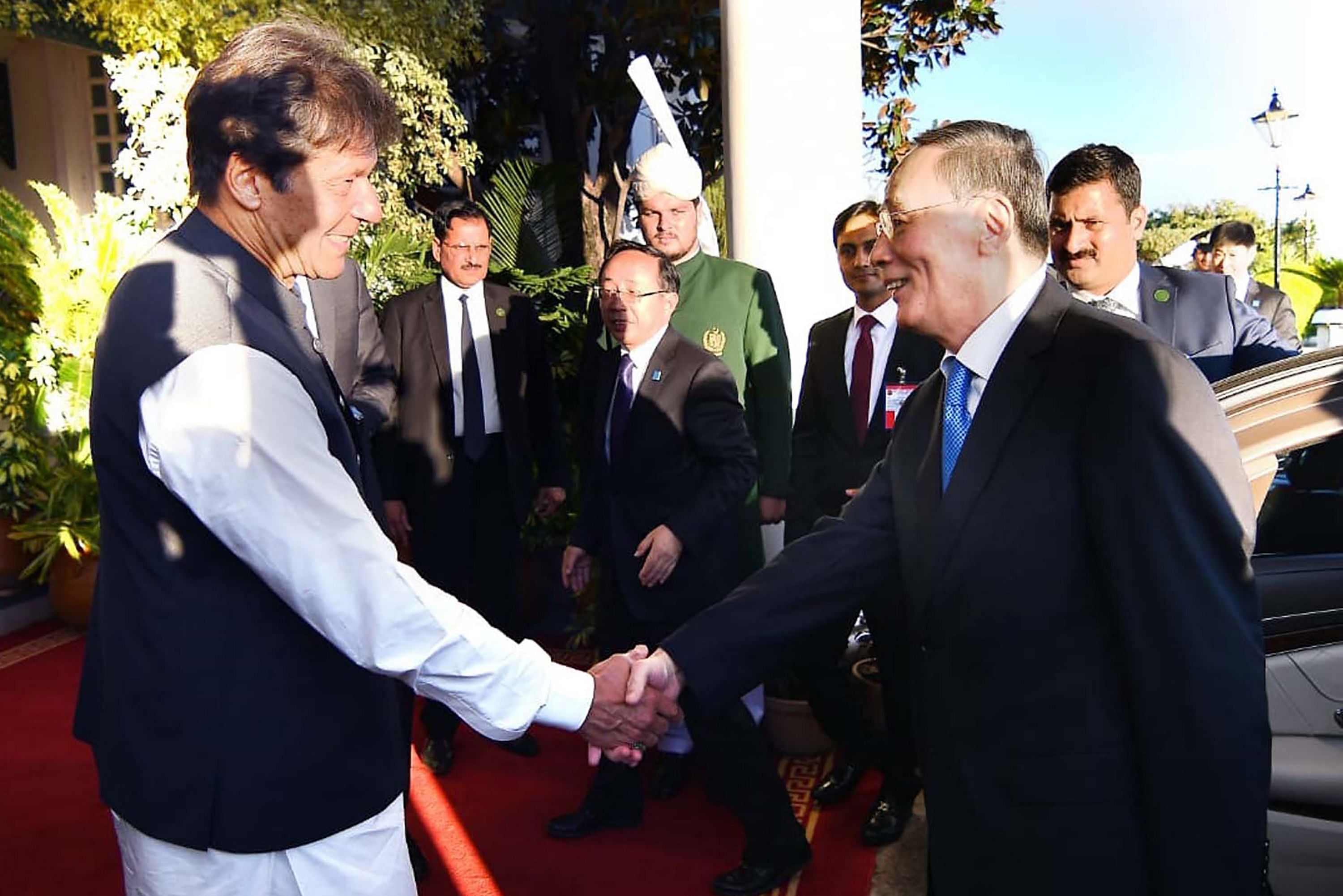 Pakistani Prime Minister Imran Khan (L) shaking hands with Chinese Vice President Wang Qishan on his arrival for a meeting in Islamabad. (AFP file photo)