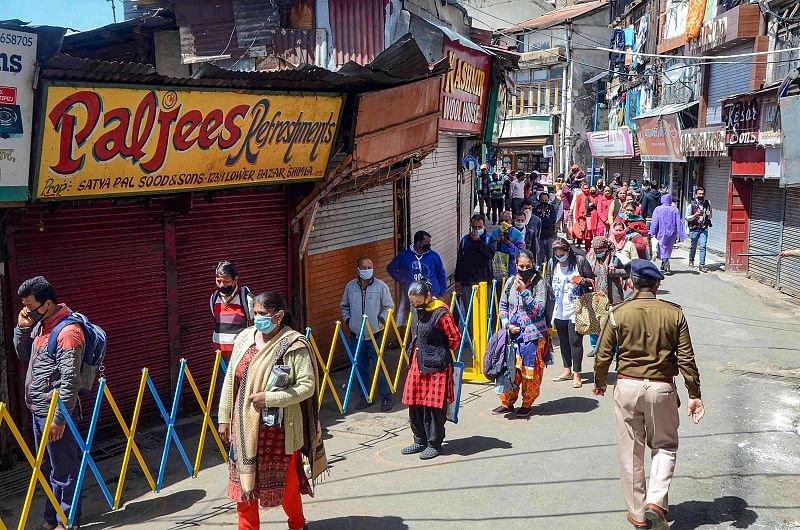 People maintaining safe distance stand in queue to buy vegetables during the ongoing nationwide lockdown imposed in the wake of coronavirus pandemic. (PTI Photo)