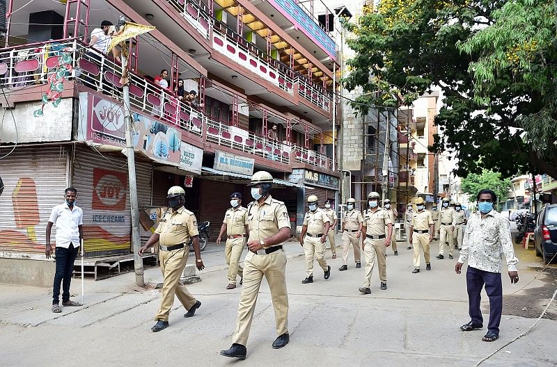 Police personnel conduct a flag march to urge citizens to stay at home during a nationwide lockdown. (PTI Photo)