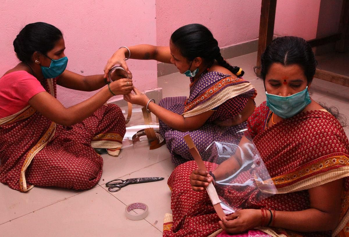 Women sheltered at the orphan home busy making masks in Ballari. 