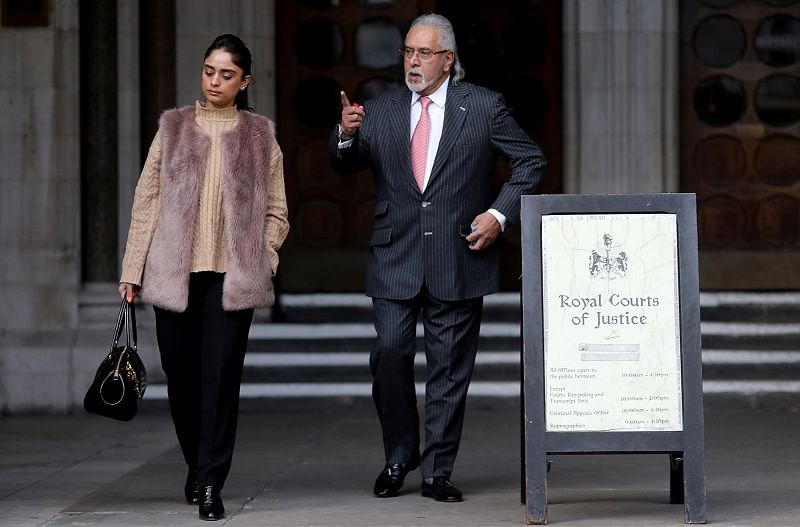 Indian businessman Vijay Mallya and his partner Pinky Lalwani leave the Royal Courts of Justice in London. (Reuters Photo)