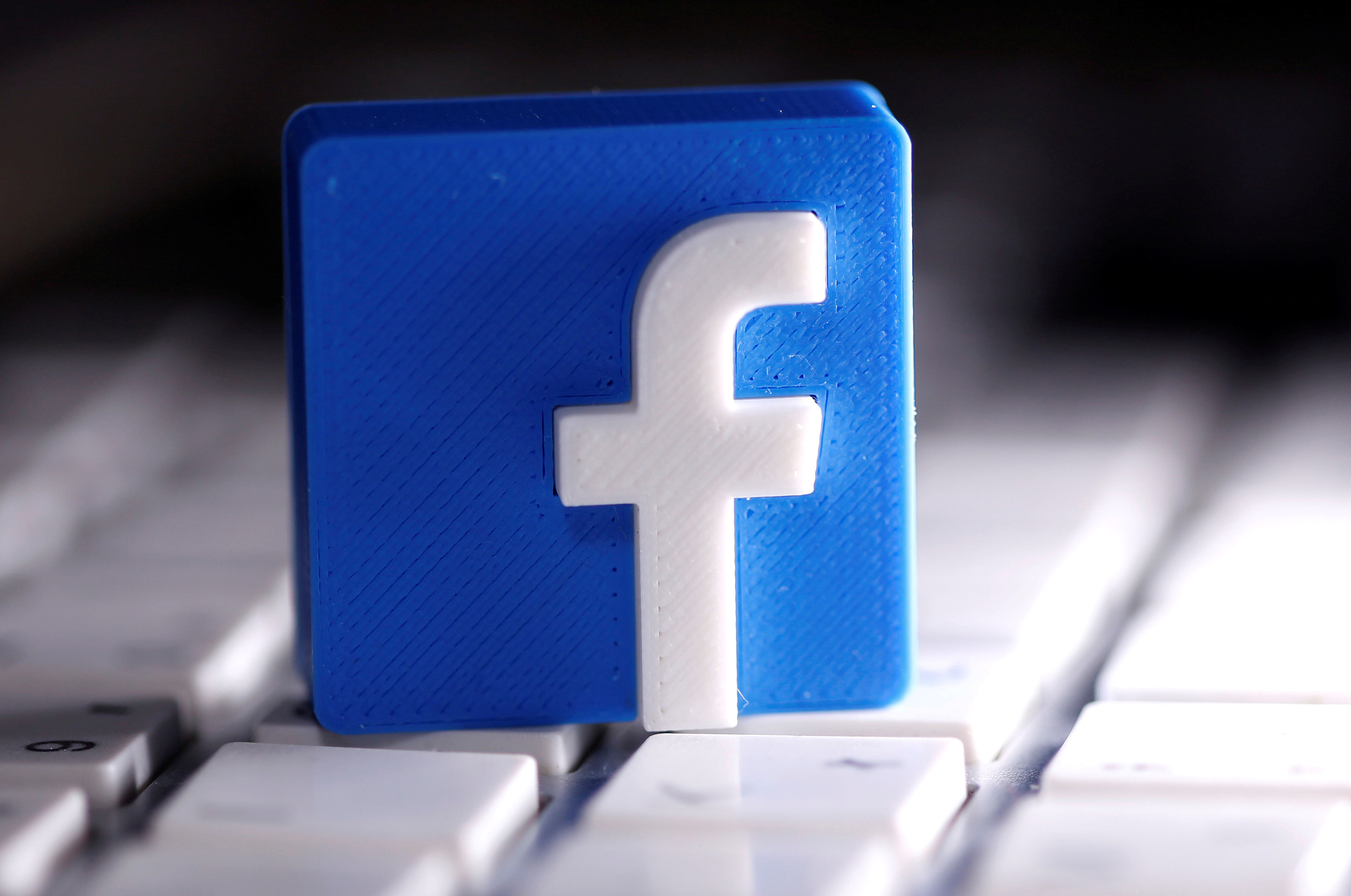 A 3D-printed Facebook logo is seen placed on a keyboard in this illustration. (Reuters Photo)