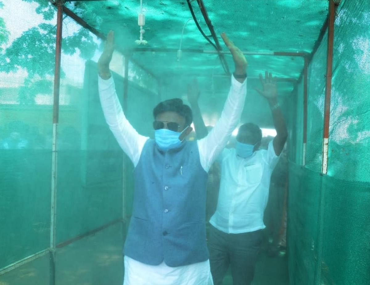 District In-charge minister Dr K Sudhakar inaugurates disinfection tunnel setup at vegetable market in Chikkaballapur on Friday.