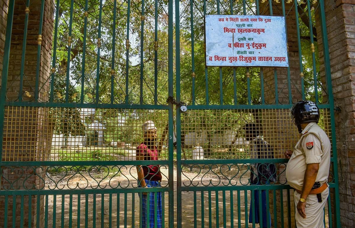 A policeman stands guard outside a graveyard (PTI Photo)