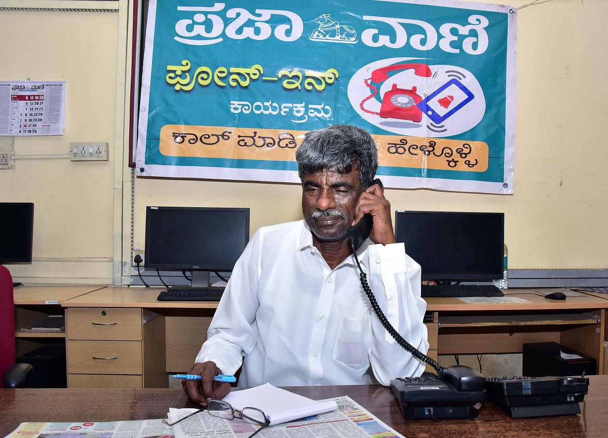 District In-charge Minister Kota Srinivas Poojary listens to a caller during the PV-DH phone-in-programme organised at the bureau office in Mangaluru on Saturday.