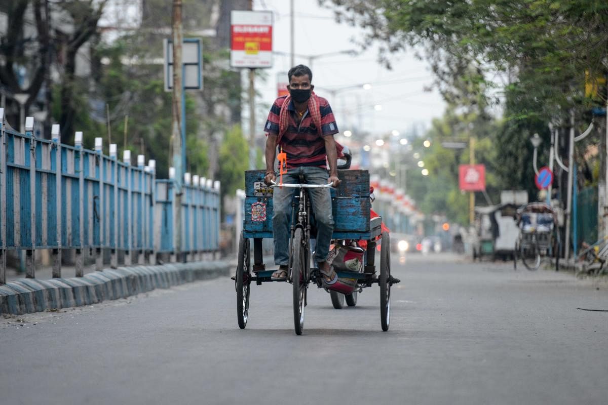 A worker rides a tricycle on a deserted street during a government-imposed nationwide lockdown as a preventive measure against the COVID-19 coronavirus, in Siliguri on April 11, 2020. Credit: AFP Photo