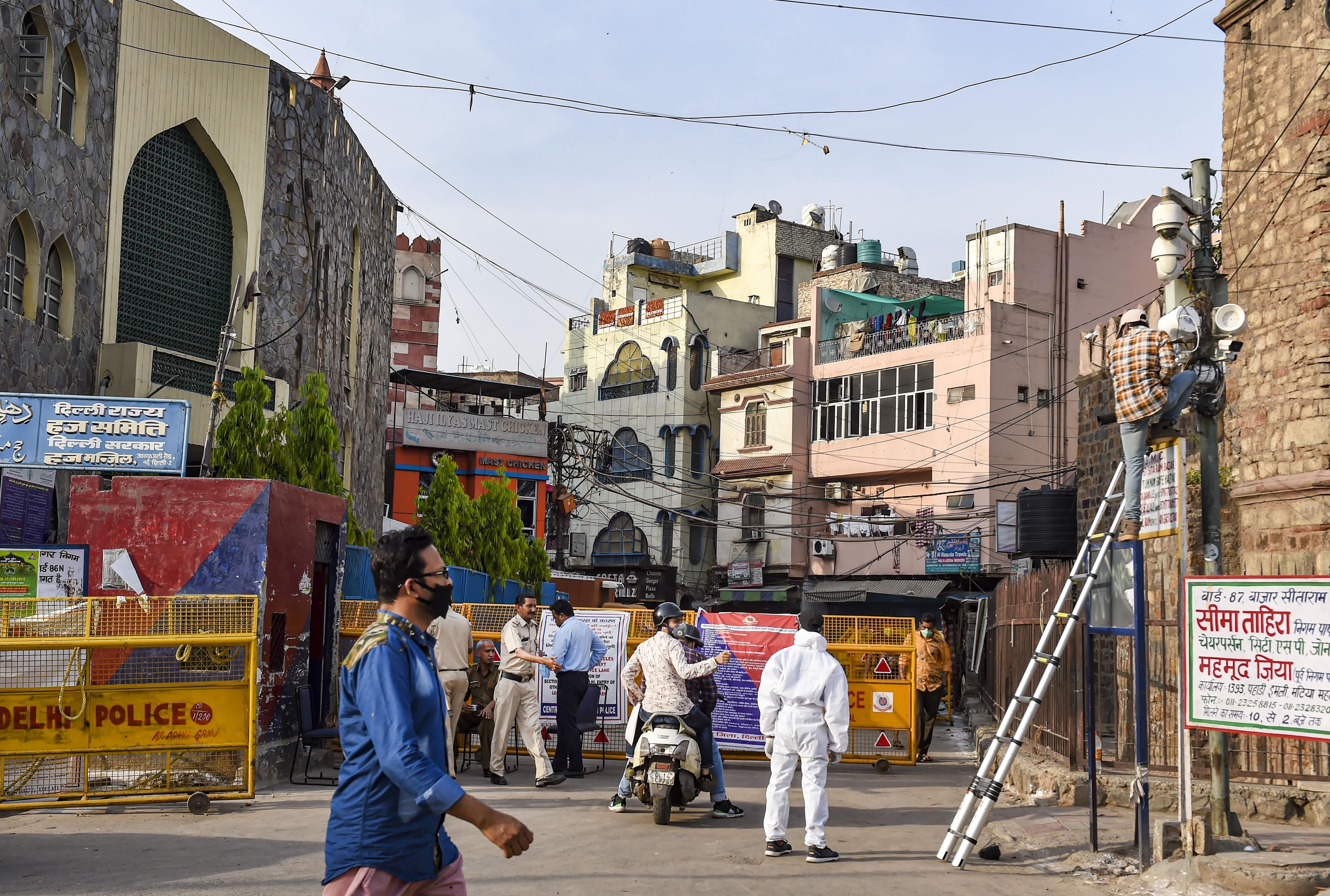  A worker sets CCTV around Chandni Mahal area, identified as a COVID-19 containment zone, during the nationwide lockdown to curb the spread of coronavirus, in Old Delhi. (Credit: PTI Photo)