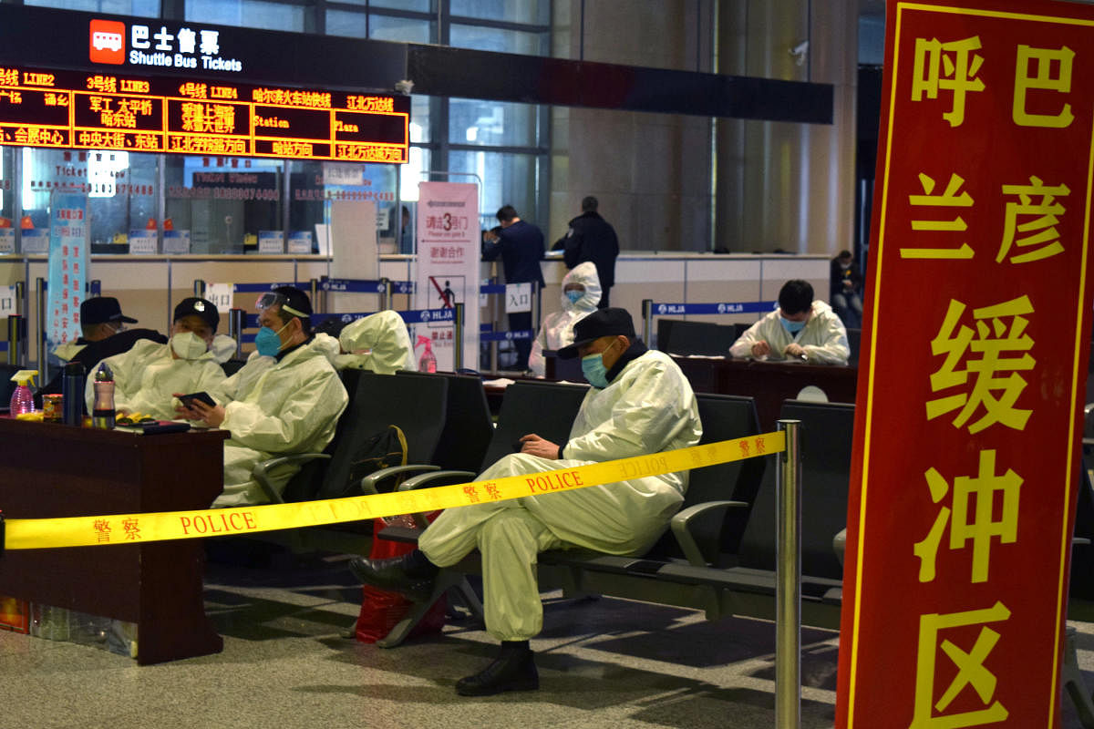 Police officers in protective suits are seen at an airport in Harbin in China (Reuters Photo)