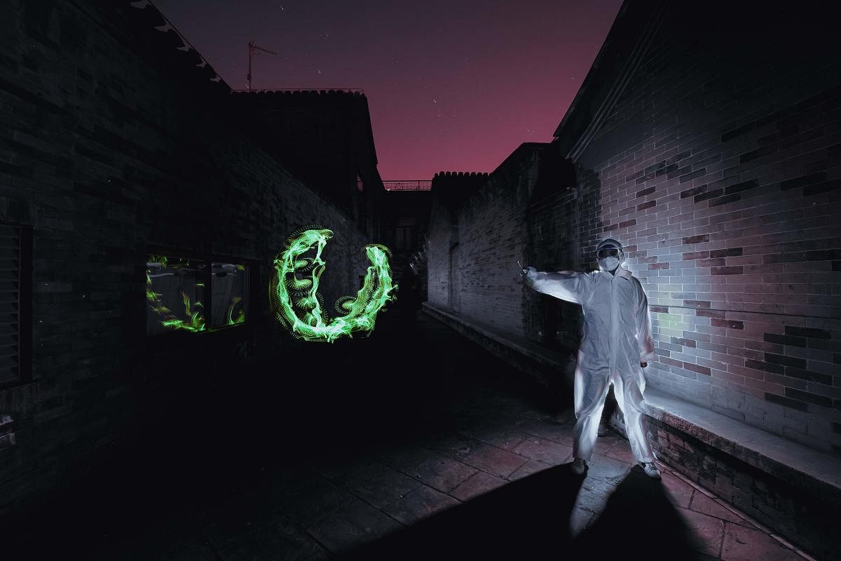 The Beijing-based artist has paid tribute to doctors and nurses and their months-long battle to treat virus-stricken patients in his latest light painting creations. (Photo by AFP)