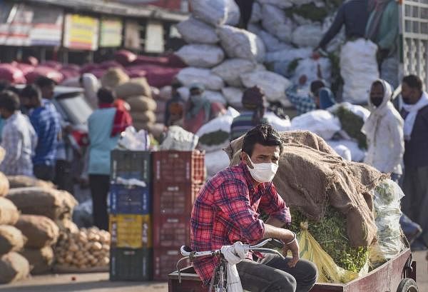 A vendor selling vegetables waits for customers at Sahibabad market, during the nationwide lockdown to curb the spread of coronavirus, in Ghaziabad. (PTI Photo/Atul Yadav) 