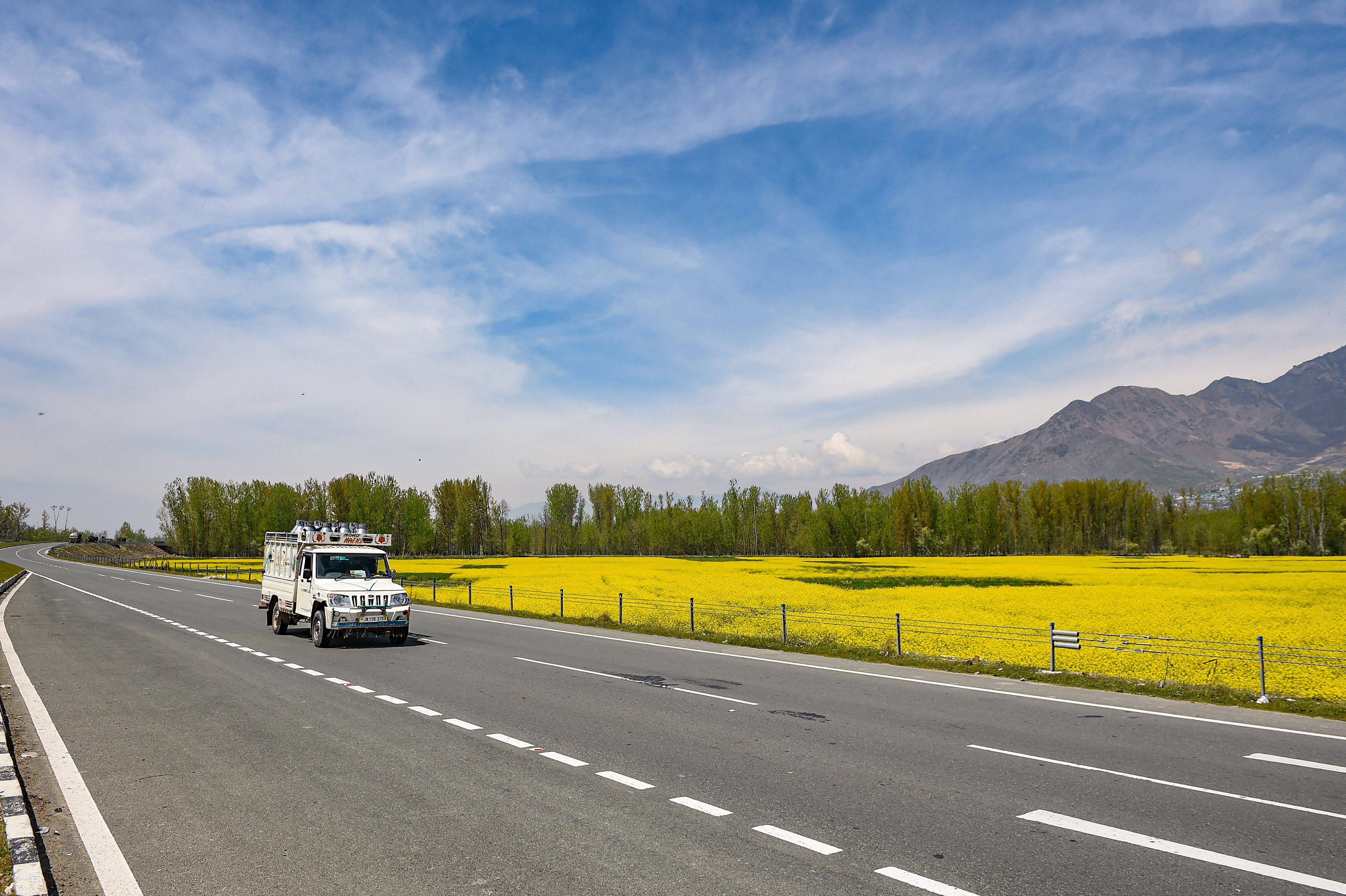 A vehicle carrying diary products runs on the deserted Srinagar-Jammu National Highway during the nationwide lockdown to curb the spread of coronavirus, in the outskirts of Srinagar. (Credit: PTI Photo)
