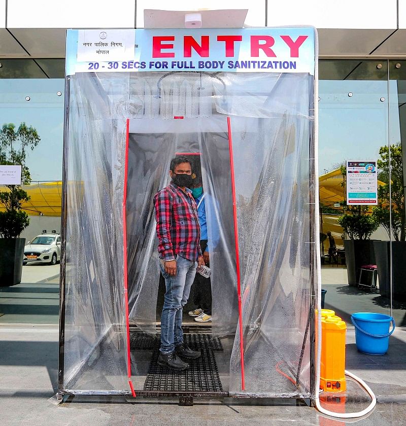  A man is seen inside a full-body sanitization machine, installed by BMC in Smart city control room amid a nationwide lockdown in the wake of coronavirus pandemic, in Bhopal,. (PTI Photo)