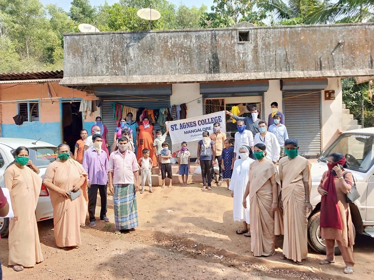 Representatives from St Agnes College distribute grocery kits to migrant labourers in Neermarga.