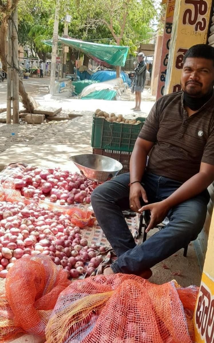 Ravi, a barber, now sells vegetables to earn some money in front of his saloon in Chikkaballapur