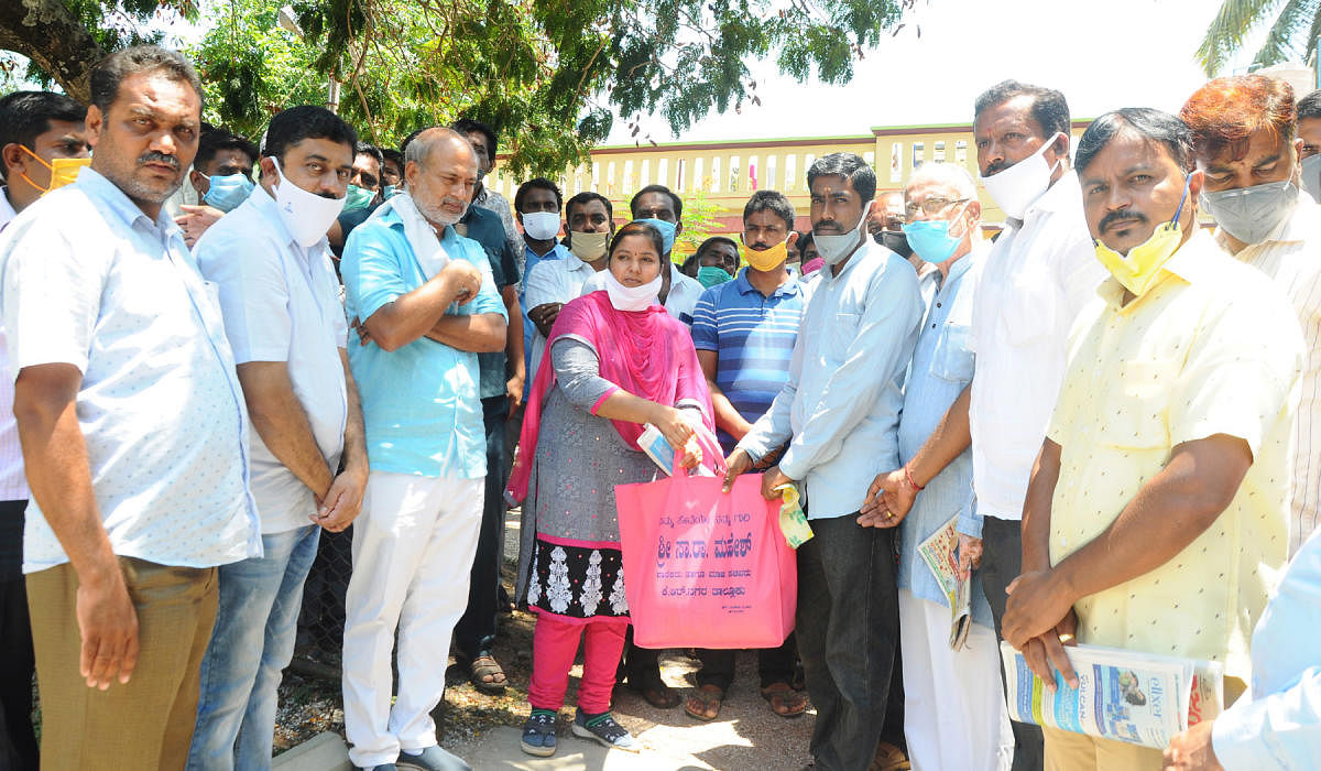 MLA Sa Ra Mahesh distributes kits to the needy in K R Nagar town on Sunday.