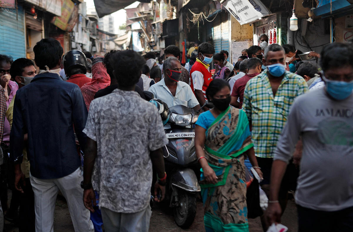 A man rides a scooter through a crowded market area, during a nationwide lockdown in India to slow the spread of COVID-19, in Dharavi, one of Asia's largest slums, during the coronavirus disease outbreak, in Mumbai, India, April 9, 2020. Credit: AFP Photo