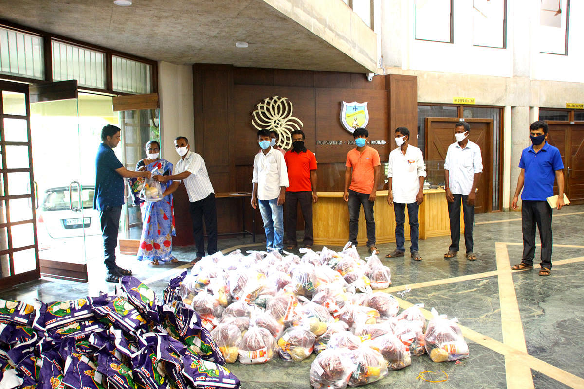 Rev Fr Rohith D’Costa, assistant director of St Joseph Engineering College, hands over a kit to the representatives of Neermarga Gram Panchayat.