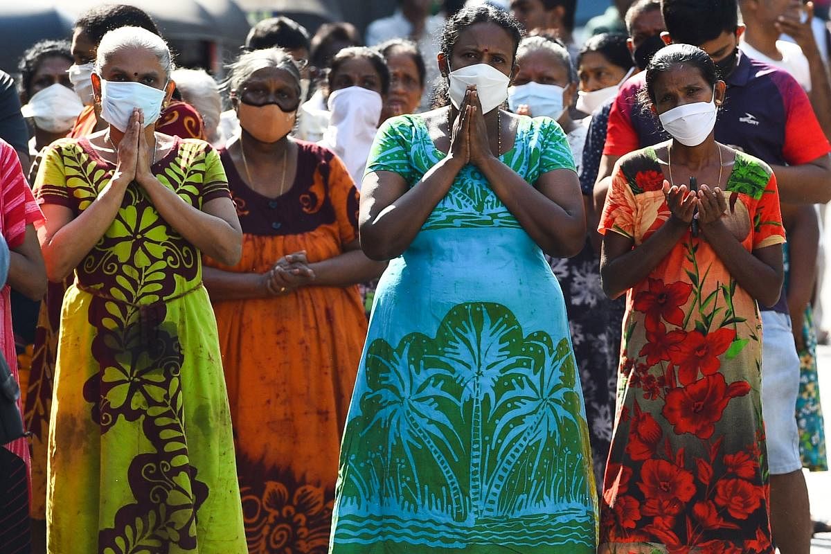 People pray near the St. Anthony’s church on the first anniversary of the Easter Sunday attacks in Colombo on April 21, 2020.  Credit: AFP Photo