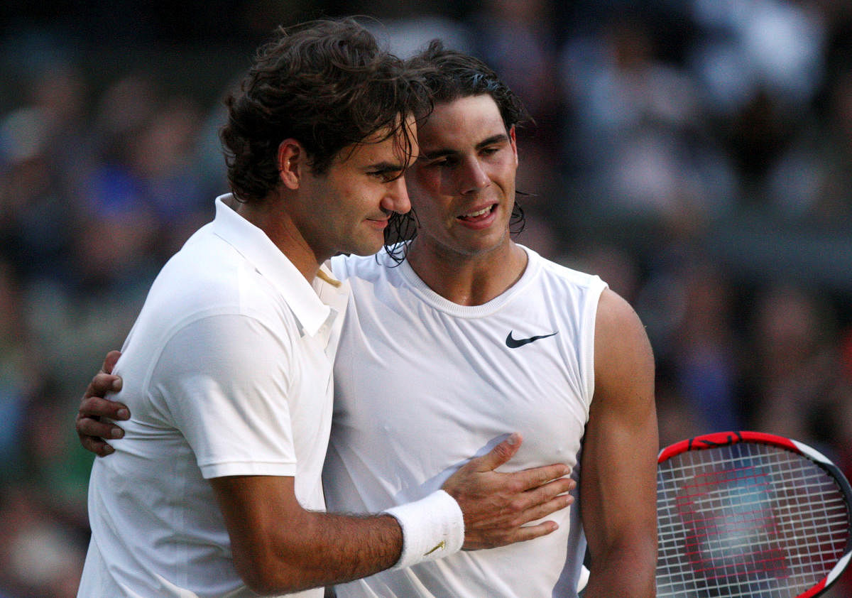 Rafael Nadal of Spain (R) is embraced by Roger Federer of Switzerland after defeating him in their finals match at the Wimbledon tennis championships in London July 6, 2008. Credit: Reuters File Photo