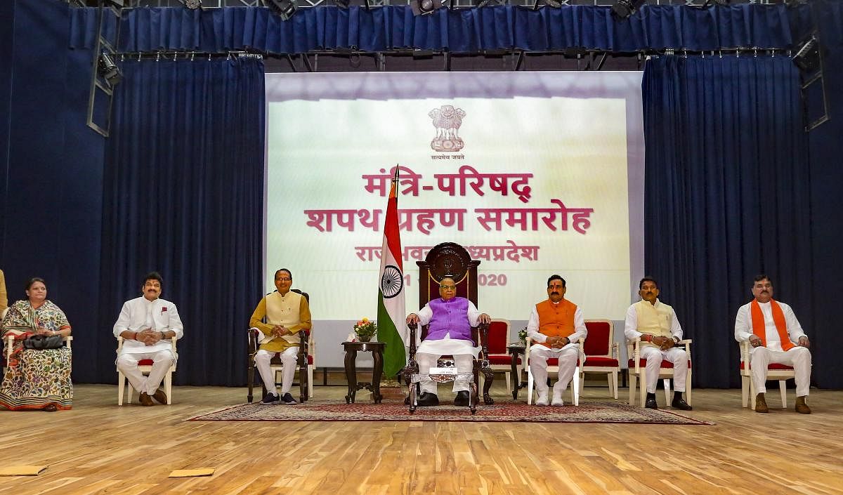 Madhya Pradesh Governor Lalji Tandon along with Chief Minister Shivraj Singh Chouhan and Cabinet Ministers Meena Singh (L), Govind Singh Rajput (2L), Narottam Mishra (3R), Tulsi Silawat (2R) and Kamal Patel (R) during the swearing-in ceremony, at Raj Bhavan in Bhopal. PTI