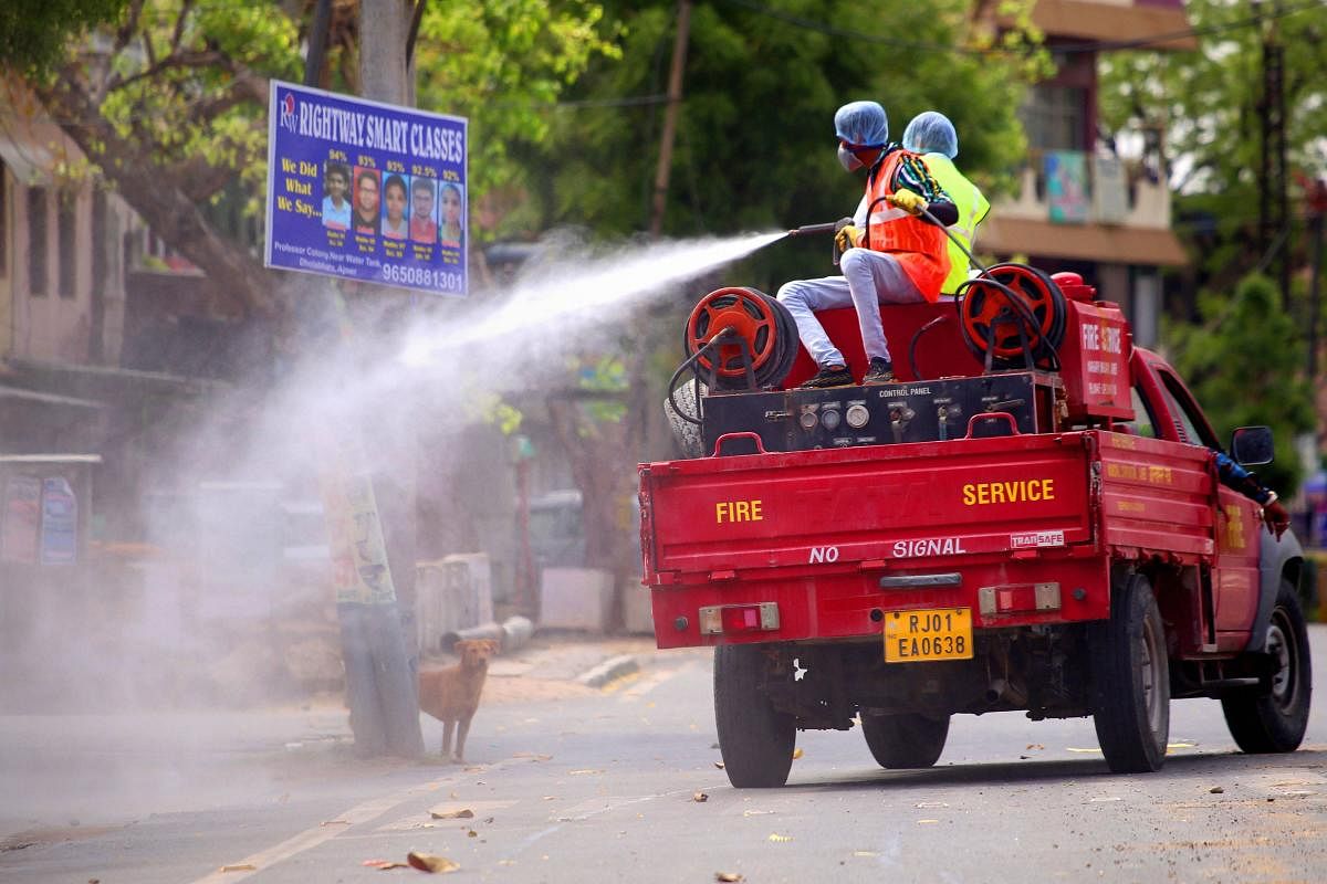 Firefighters spray disinfectant on a street in Rajasthan (PTI Photo)