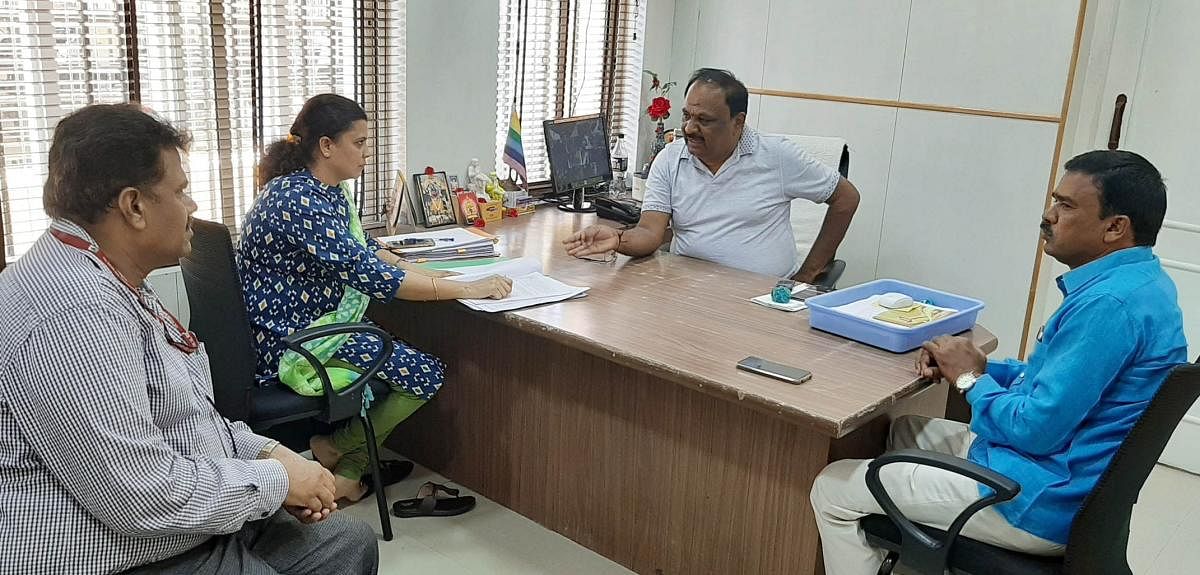 DCC Bank President M Govinda Gowda discusses the proposal on Pradhan Mantri Fasal Bhima Yojana with Horticulture department deputy director Gayatri in Kolar on Wednesday.