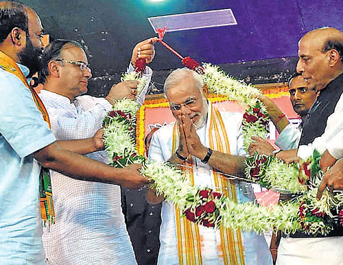 Gujarat Chief Minister Narendra Modi is garlanded by BJP president Rajnath Singh (right), Arun Jaitley (second left) and others during the party national executive meeting in Panaji, Goa, on Sunday. AP