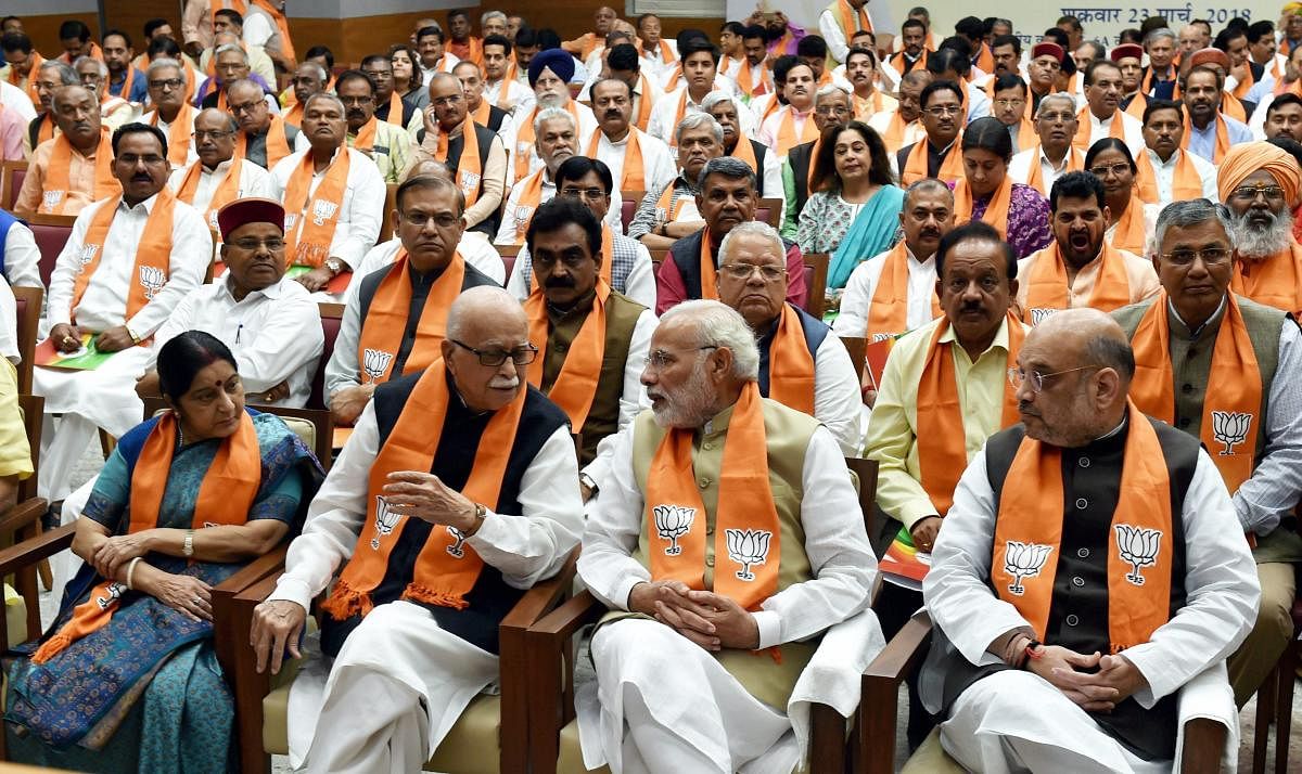 Prime Minister Narendra Modi talks with BJP Senior Leader L K Advani as BJP President Amit Shah and External Affairs Minister Sushma Swaraj look on during the BJP Parliamentary party meeting at party headquarters in New Delhi on Friday. PTI Photo