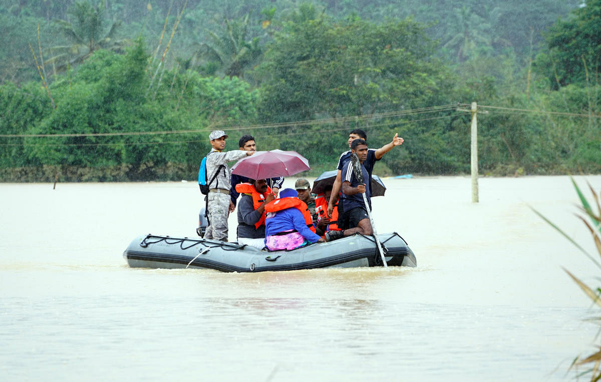 Rescue team personnel at work in Myladi village in Wayanad district on Friday. DH Photo