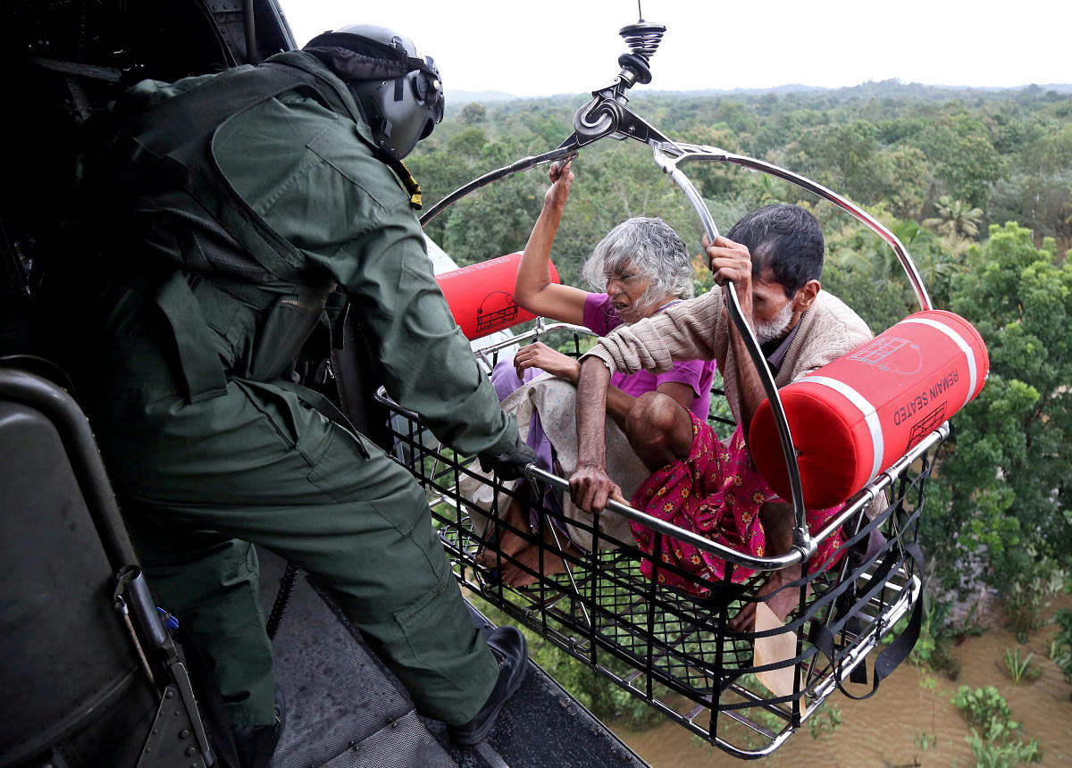 People are airlifted by the Indian Navy soldiers during a rescue operation at a flooded area in Kerala. Reuters file photo