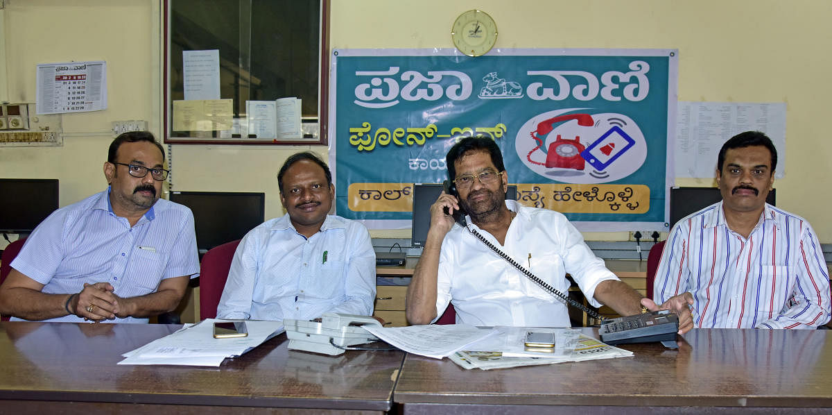 SCDCC Bank President M N Rajendra Kumar receives a call during the DH-PV phone in programme organised at DH-PV editorial office in Balmatta on Friday. Cooperative Societies Deputy Registrar B K Salim, Assistant Registrar Manjunath Singh and SCDCC Bank GM