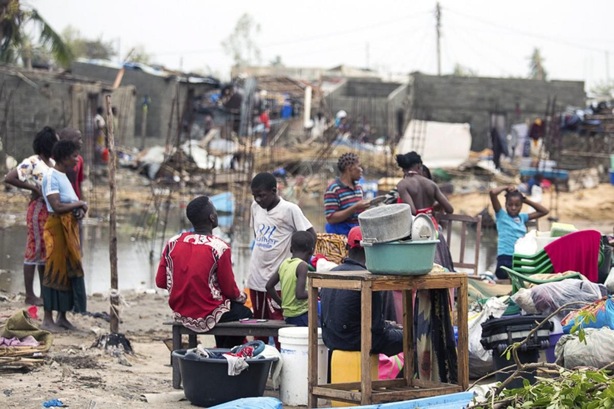 In this photo taken on Friday, March 15, 2019 and provided by the International Red Cross, People salvaging what is left of their belongings after Tropical Cyclone Idai, in Beira, Mozambique. Mozambique's President Filipe Nyusi says that more than 1,000 m