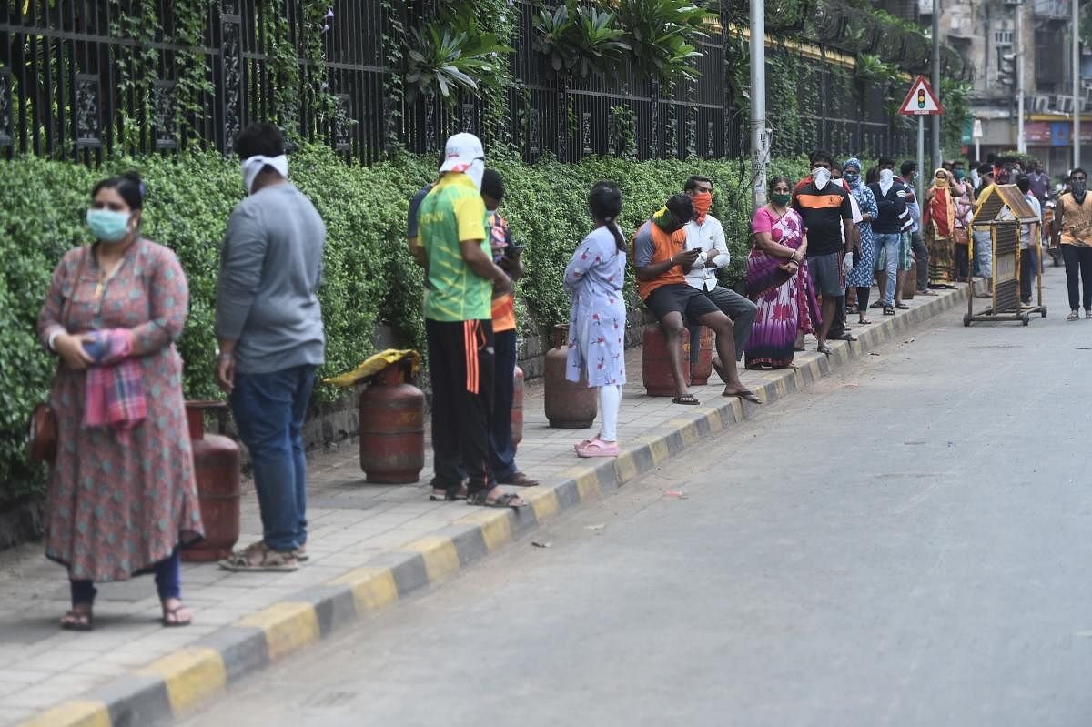  People wearing masks stand in a queue in Mumbai (PTI Photo)