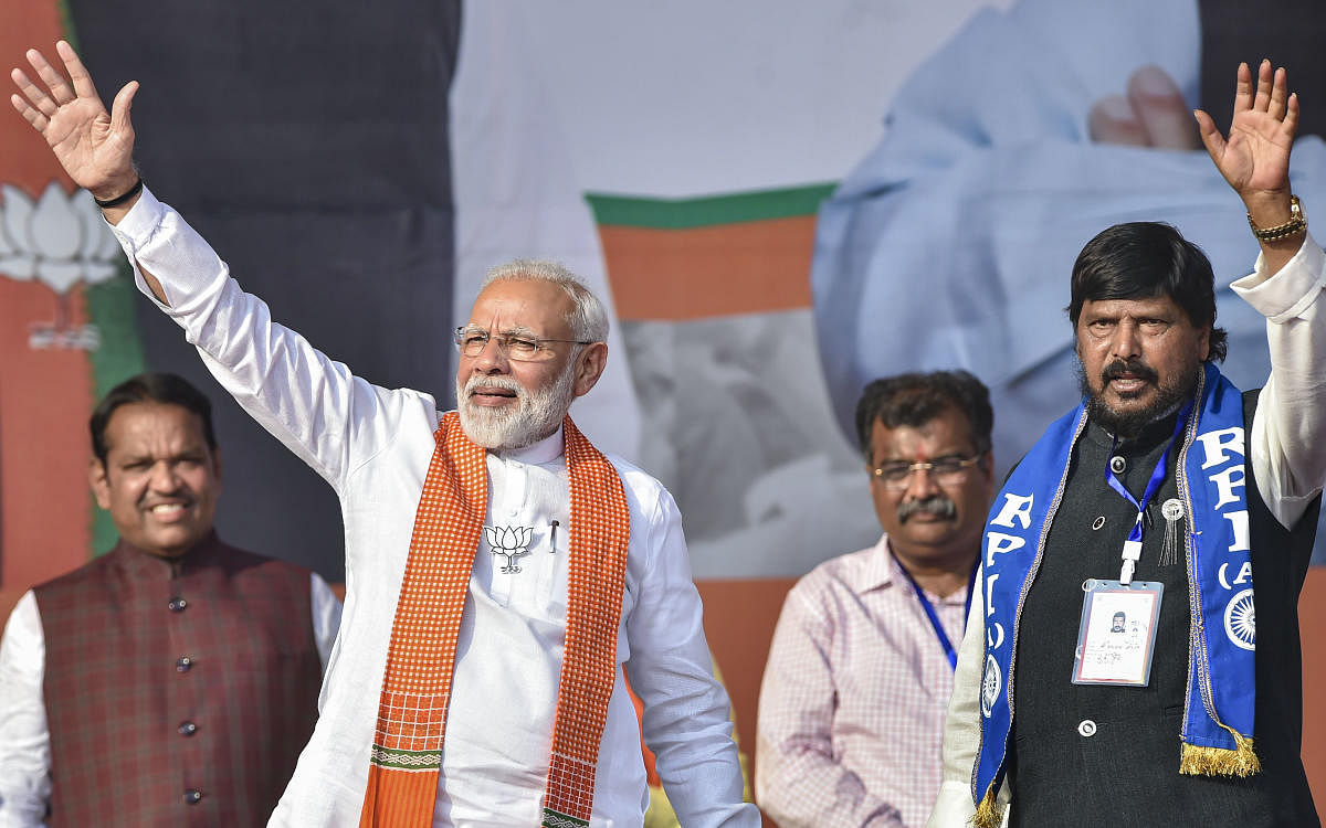 Prime Minister Narendra Modi with RPI leader Ramdas Athawale waves at the crowd during an election rally ahead of Maharashtra Assembly elections, at Kharghar in Navi Mumbai. PTI